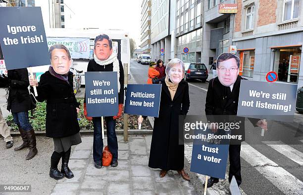 Members of Open Europe stage a protest outside EU headquarters, holding placards of EU leaders ahead of the summit in Brussels, Belgium, on Thursday,...