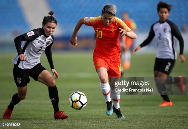 Li Ying of China and Natthakarn Chinwong of Thailand chase the ball during the AFC Women's Asian Cup third place match between China and Thailand at...