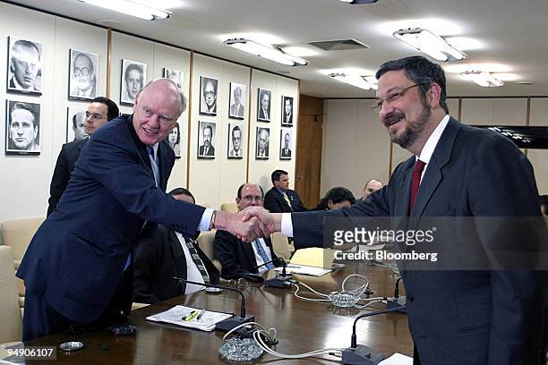 Treasury Secretary John Snow, left, shakes hands with Brazil's Finance Minister Antonio Palocci at the start of a meeting in Brasilia, Brazil Monday,...