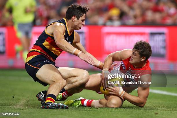 Tom Papley of the Swans contests the ball Jake Kelly of the Crows during the round five AFL match between the Sydney Swans and the Adelaide Crows at...