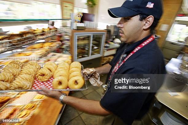 Tony Espinlnal carries a tray of fresh doughnuts in a Tim Hortons doughnut franchise on Friday, July 29, 2005 in Groton, Connecticut. Wendy's...