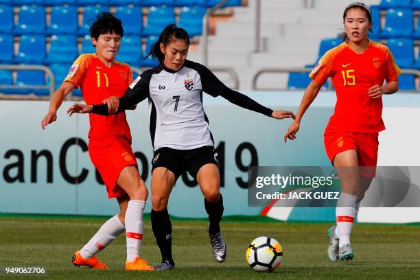 Thailand's midfielder Silawan Intamee vies for the ball with China's forward Shanshan Wang during the AFC Women's Asian Cup match for third place...