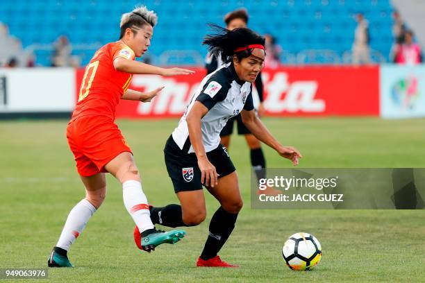 Thailand's midfielder Kanjana Sung-Ngoen vies for the ball with China's forward Ying Li during the AFC Women's Asian Cup match for third place...