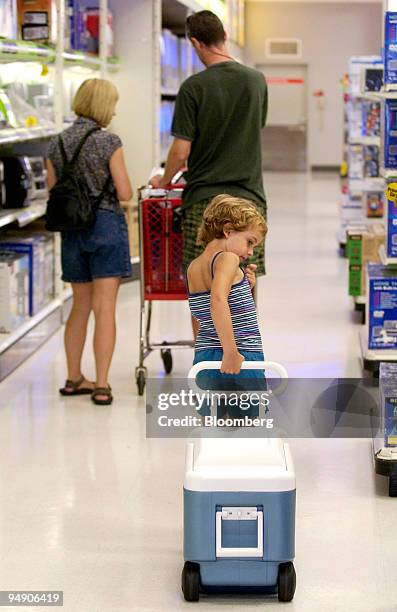 Keely Walsh of Philadelphia, Pennsylvania, pulls a cooler behind her parents Joe and Kim, at a Target store in Plymouth Meeting, Pennsylvania,...