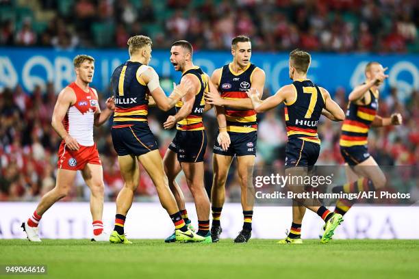 Rory Atkins of the Crows celebrates kicking a goal with team mates during the round five AFL match between the Sydney Swans and the Adelaide Crows at...