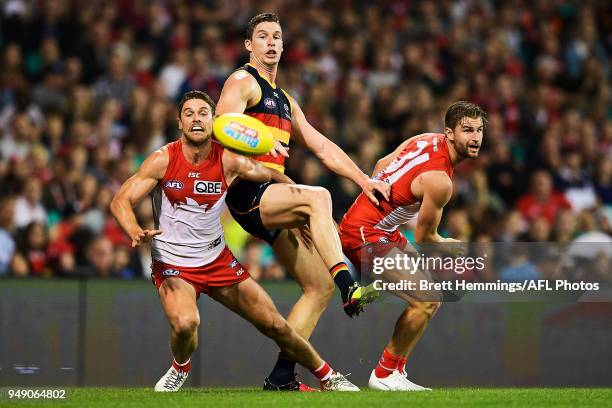 Dane Rampe of the Swans, Harry Marsh of the Swans and Josh Jenkins of the Crows contest the ball during the round five AFL match between the Sydney...