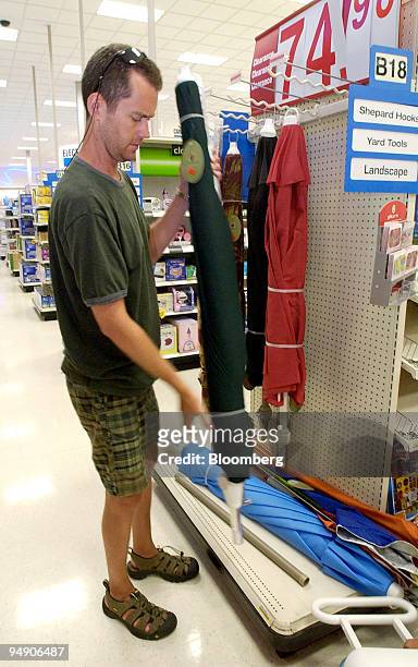 Joe Walsh, of Philadelphia, Pennsylvania, looks over beach umbrellas, at a Target store in Plymouth Meeting, Pennsylvania, Thursday, July 8, 2004....