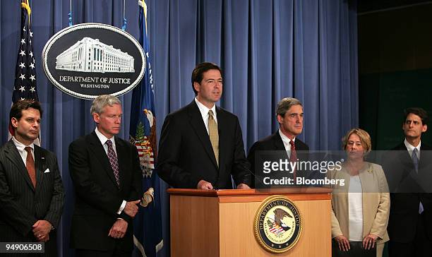 Deputy Attorney General James B. Comey, third from left at podium, makes a statement on the indictment of former Enron Corp CEO Kenneth L. Lay, at...