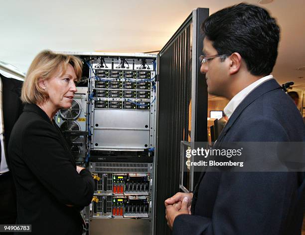 Employees Maureen McGuire and Prashant Pandey look over an IBM computer Thursday, July 26, 2005 during the launch of IBM's new z9 mainframe computer...