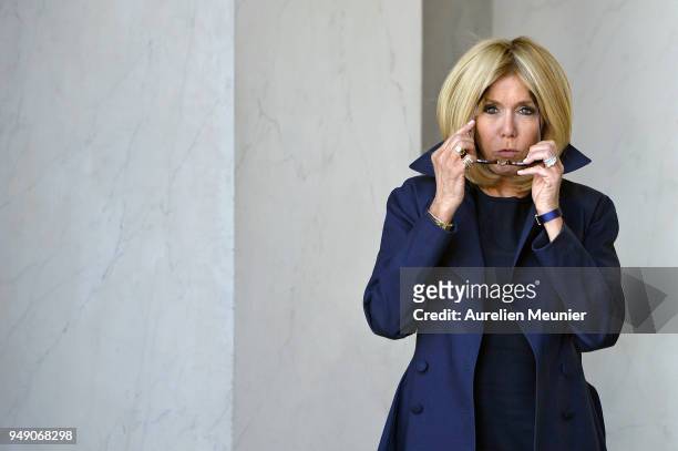 French First Lady Brigitte Macron leaves the Elysee Palace to attend the tribute to fallen police officer Xavier Jugele on April 20, 2018 in Paris,...