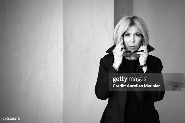 French First Lady Brigitte Macron leaves the Elysee Palace to attend the tribute to fallen police officer Xavier Jugele on April 20, 2018 in Paris,...