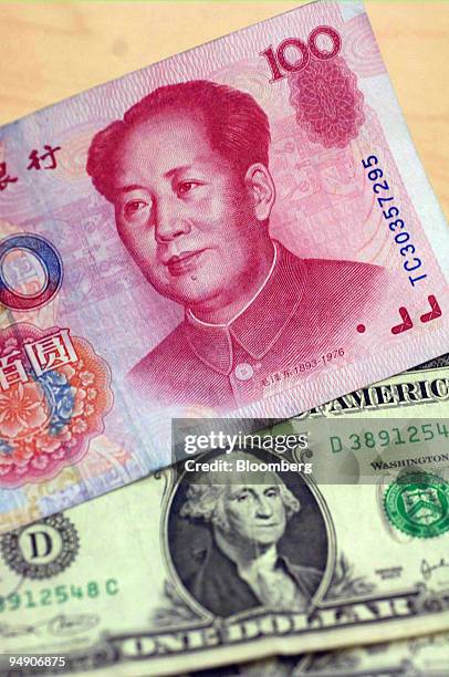 Chinese 100 Yuan note is pictured with a US one dollar bill in an American Express travel related services office in New York Thursday, July 21,...