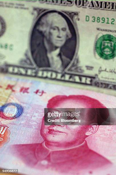Chinese 100 Yuan note is pictured with a US one dollar bill in an American Express travel related services office in New York Thursday, July 21,...