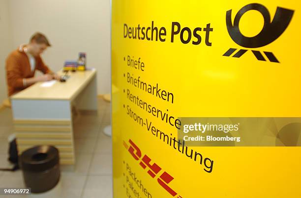 Customer fills out forms in a Deutsche Post branch in Frankfurt, Germany, Tuesday, July 26, 2005. Deutsche Post AG, Europe's biggest postal service,...