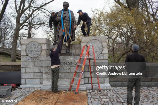 In front of a small crowd of activists and media, city workers remove a statue of J. Marion Sims, a surgeon and medical pioneer in the field of...