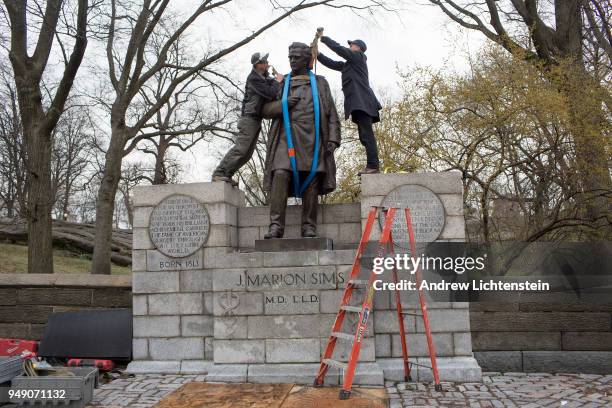 In front of a small crowd of activists and media, city workers remove a statue of J. Marion Sims, a surgeon and medical pioneer in the field of...