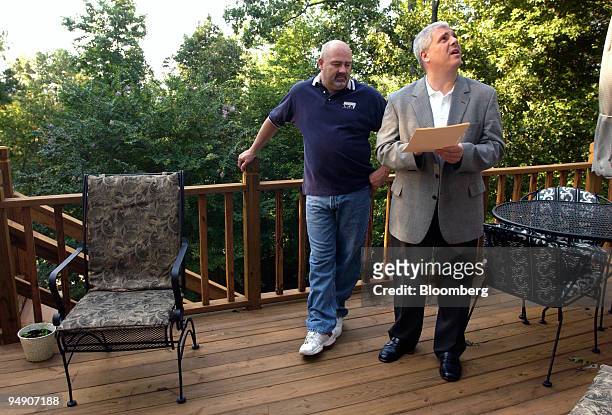 Larry Wiginton, left, shows realtor Joe Falconer through his home during the listing procedure of the property in Hoover, a suburb of Birmingham,...