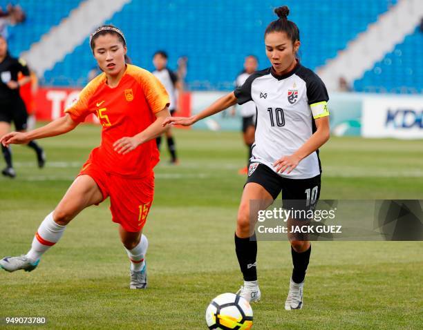 Thailand's midfielder Sunisa Strangthaisong vies for the ball with China's midfielder Duan Song during the AFC Women's Asian Cup match for third...