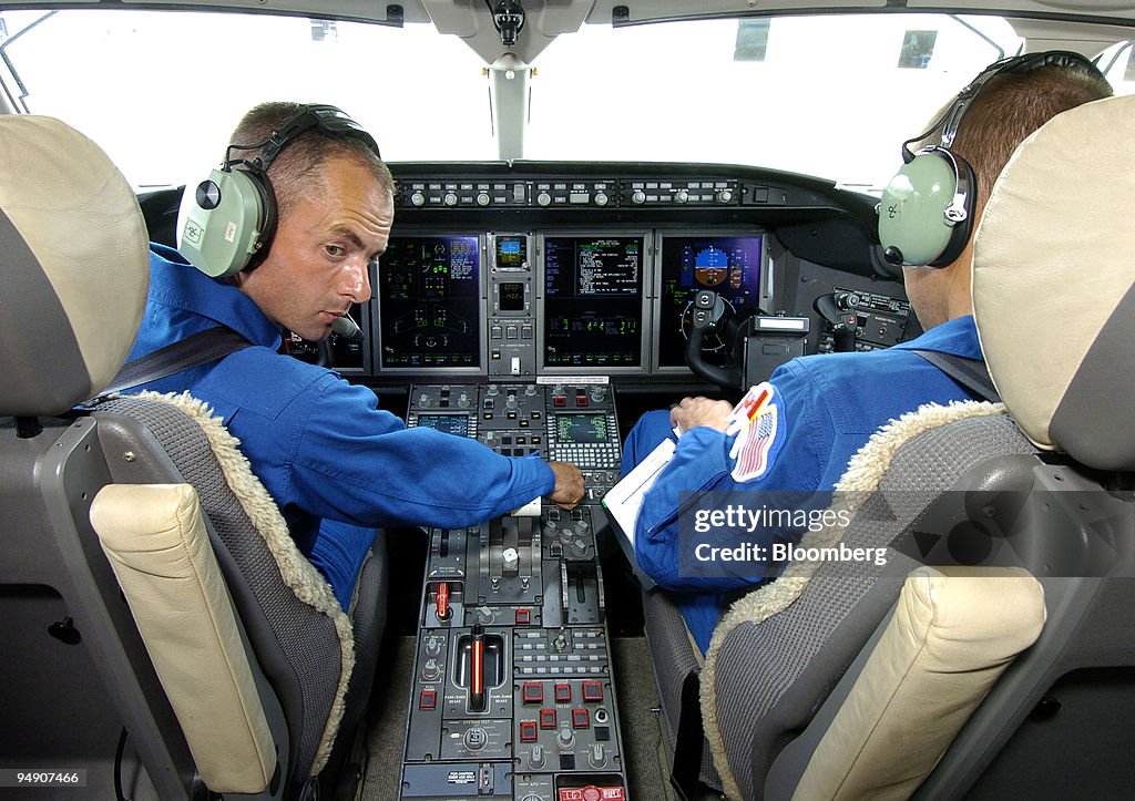 Test pilot Doug May, left, glances back into the cabin as he