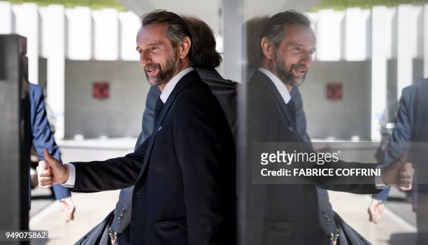 Paris Saint-Germain's assistant general manager Jean-Claude Blanc gives a thumb up after a hearing on UEFA Financial Fair Play Regulations at the...