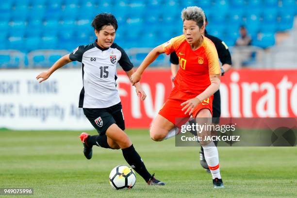 Thailand's midfielder Nipawan Panyosuk vies for the ball with China's forward Ying Li during the AFC Women's Asian Cup match for third place between...