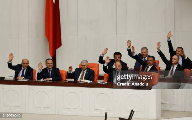 Turkish Prime Minister Binali Yildirim, Turkish Deputy Prime Minister Recep Akdag, Bekir Bozdag and Fikri Isik are seen as they vote for the proposed...