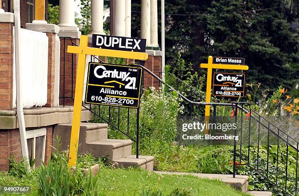 Two homes are for sale in Philadelphia, Pennsylvania, Friday, June 25, 2004. U.S. Sales of previously owned homes unexpectedly rose to a record 6.8...