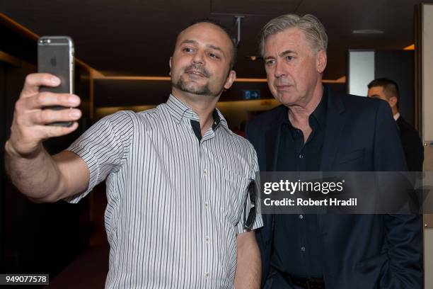 Head Coach Carlo Ancelotti poses for selfie with fan after the Press Conference of Match for Solidarity on April 20, 2018 at Grand Hotel Kempinski in...