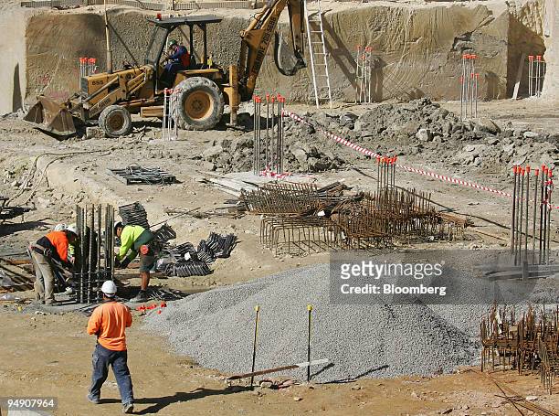 Workmen use heavy machinery as they prepare the steel cores for concrete foundations at a commercial property under construction in Sydney, Australia...