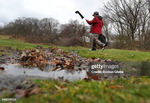 John Wong from Jamaica Plain walks past a puddle on the third fairway at the George Wright Golf Course in the Hyde Park neighborhood of Boston on...