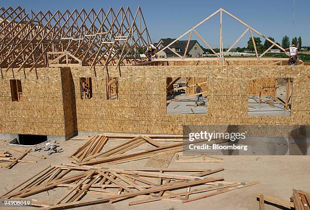 Roof trusses are moved into position during construction on a home in the Cavallo housing development in Eagle, Idaho Saturday, July 16, 2005.