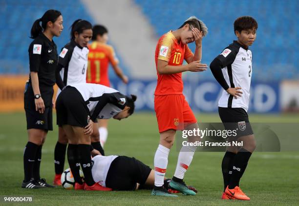 Li Ying of China reacts after clashing with Pikul Khueanpet of Thailand during the AFC Women's Asian Cup third place match between China and Thailand...