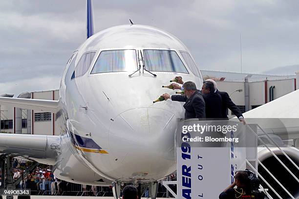Brazilian President Luiz Inacio Lula da Silva is joined by Embraer CEO Mauricio Botelho and Chairman Carlyle Wilson in christening the company's...