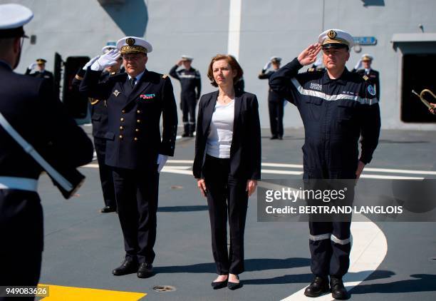 French Defence Minister Florence Parly listens to the French national anthem onboard the FREMM 'Languedoc' in Toulon, southern France, on April 20...