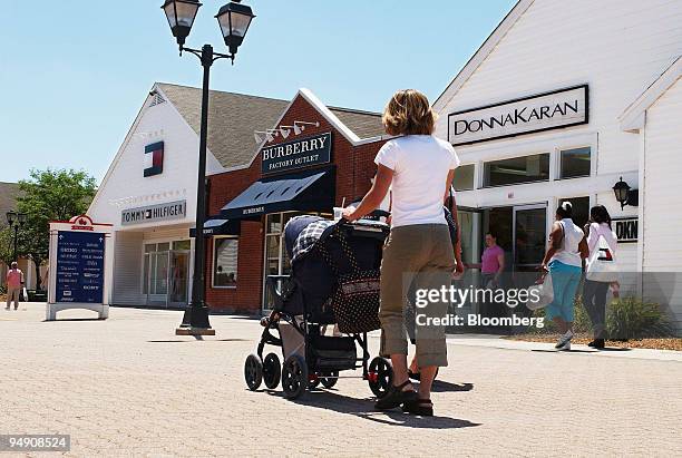 Shoppers walk around the Woodbury Common Premium Outlets in Central Valley, New York, Monday, June 21, 2004. Simon Property Group Inc., the world's...