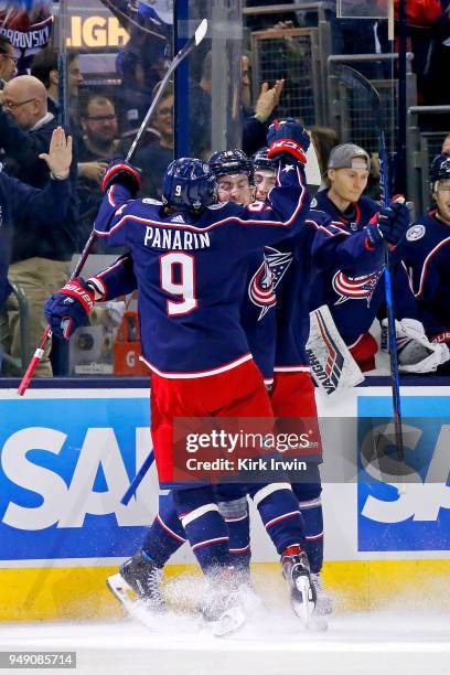 Pierre-Luc Dubois of the Columbus Blue Jackets is congratulated by Artemi Panarin of the Columbus Blue Jackets and Zach Werenski of the Columbus Blue...