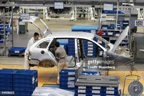 Workers assemble Skoda Fabia cars at the Skoda plant in Mlada Boleslav, Czech Republic, Friday, June 18, 2004.