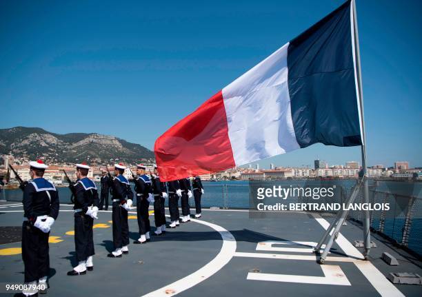 French navy soldiers stand next to a French flag prior to French Defence Minister's visit onboard the FREMM 'Languedoc' in Toulon, southern France,...