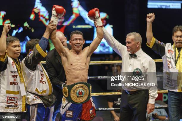 Filipino boxer Michael Dasmarinas celebrates after defeating French opponent Karim Guerfi during the International Boxing Organisation Batamweight...