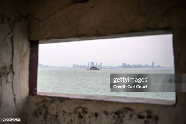 Shiyu, or Lion Islet, part of Kinmen County, one of TaiwanÕs offshore islands, is viewed through the hole of guard tower in front of the Chinese city...