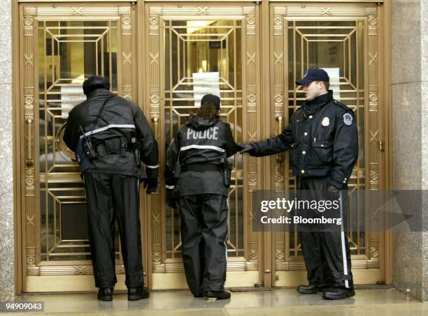 Capitol Hill Police stand near an entrance of the Dirksen Senate Office Building in Washington, DC, February 3, 2004. U.S. Senate offices closed...