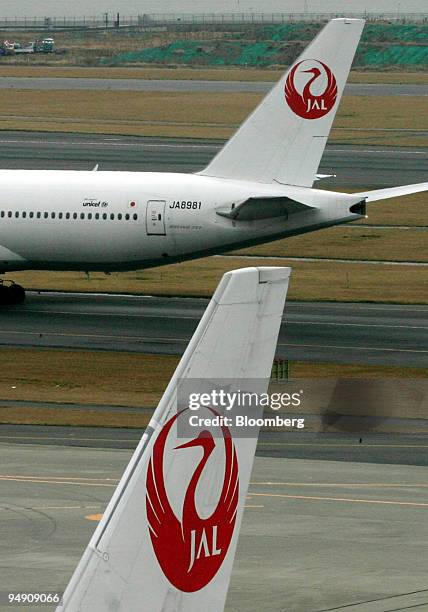 Japan Airlines Co. Ltd. Passenger jets move past each other at Haneda Airport in Tokyo Tuesday, February 3, 2004. Japan Airlines System Corp., Asia's...