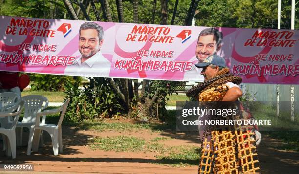 Man walks by electoral propaganda of the presidential candidate for the Colorado party, Mario Abdo Benitez, ahead of the upcoming April 22...