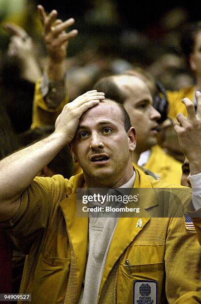 Clerk in the Eurodollars futures pit at the Chicago Mercantile Exchange wipes his brow during trading upon the announcement that the Federal Reserve...