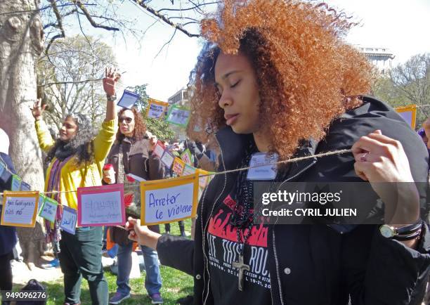 Students hold up signs to protest gun violence during a walk-out in Lafayette Square across the White House in Washington, DC on April 20, 2018. -...