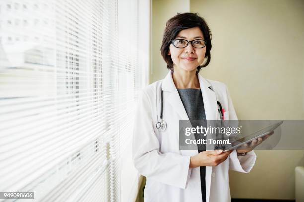 portrait of doctor holding clipboard - asian culture stock pictures, royalty-free photos & images