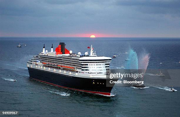 Carnival Corp.'s Queen Mary 2 is escorted into Port Everglades at Fort Lauderdale, Florida, at dawn on Monday, January 26, 2004. The biggest ocean...