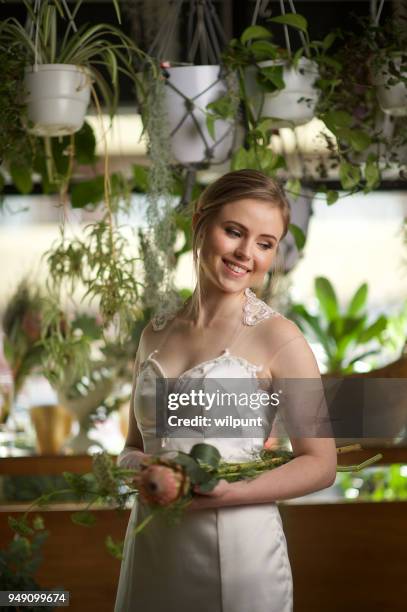 portrait of a young bride looking down - protea stock pictures, royalty-free photos & images