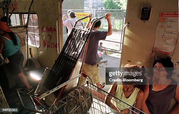 Garbage collectors trundle their carts behind them as they step down from the co-called "Tren Blanco " that carries scavengers into the center of...