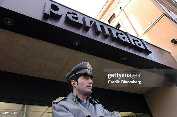 Police officer stands guard outside the Parmalat offices in Collecchio, Italy, Monday, January 19, 2004. Bank of America Corp. Said it ended an...